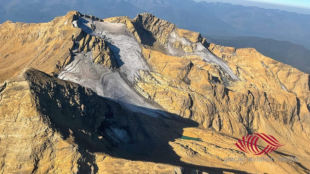 Stanton Glacier clinging to steep mountain slopes, aerial view Montana
